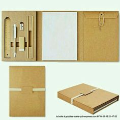 an open cardboard box with a notepad, pen and pencil