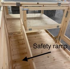 a chicken coop with an arrow pointing to the safety ramp