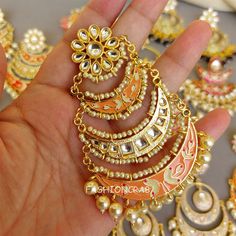 5 pair of assorted golden-toned Traditional Handmade Meenakari Earring for Women with hanging pearls. Size & Other Details Material  : Alloy, Pearl, Meena work Attire :  Lehenga Choli, Salwar Suit, Kurti, Saree, Flared Dress Pieces : 5pc Assorted design will come depending on the stock available. Gift Meenakari Chandbalis In Metal, Gift Meenakari Metal Chandbalis, Gift Meenakari Chandbalis, Kundan Meenakari Hoop Earrings As A Gift, Meenakari Metal Danglers As Gift, Gift Meenakari Danglers In Metal, Gift Meenakari Metal Danglers, Metal Danglers With Meenakari For Gift, Festive Orange Dangle Jewelry