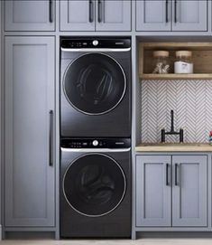 the front load washer and dryer combination is shown in this kitchen with gray cabinets