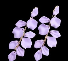 Treat yourself or surprise someone special with these exquisite earrings that are as beautiful as they are versatile. Don't miss out on the opportunity to express your individuality and embrace your inner fashionista, get yours today and let your style blossom! Elegant Spring Chandelier Earrings, Trendy Drop Flower Earrings, Elegant Purple Flower Earrings For Party, Spring Party Jewelry With Matching Earrings, Chic Dangle Flower Earrings, Elegant Handmade Spring Earrings, Chic Dangle Flower Earrings For Pierced Ears, Elegant Handmade Earrings For Spring, Chic Flower-shaped Matching Earrings