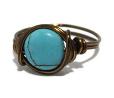 Urban boho wire Wrapped Ring Made with a 10mm Turquoise magnesite gemstone coin bead. The ring is wrapped with 18 gauge non tarnish wire. Your choice of antique brass or silver plated wire. Rings are made to order in your size. Ring may appear larger in photos to show detail. Since each ring is handmade and gemstones vary in color tone and pattern, there may be slight differences in each ring. Your order will be made and shipped within 1-5 business days of received payment. Returns and exchanges Adjustable Bohemian Turquoise Ring Nickel Free, Adjustable Spiritual Turquoise Ring, Bohemian Metal Ring With Wire Wrapping, Bohemian Turquoise Crystal Ring For Gift, Bohemian Adjustable Wire Wrapped Rings, Bohemian Turquoise Wire Wrapped Rings, Handmade Oval Turquoise Ring - Spiritual Style, Adjustable Nickel-free Bohemian Turquoise Ring, Turquoise Boho