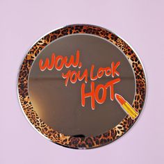 a mirror with the words wow, you look hot written on it and an orange marker