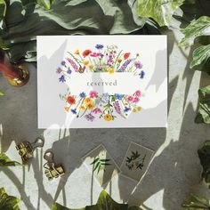 a card that says reserved surrounded by flowers