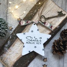 a white star ornament with the words santa's magic key on it