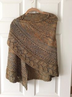 a brown shawl hanging on a white door