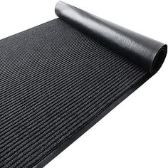 a roll of black yoga mat on top of a white surface with an extra thick rubber pad