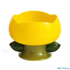 a yellow flower pot sitting on top of a green base