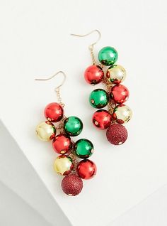 These shaky dangle earrings with red, green, and gold ornaments are perfect for accessorizing during the holiday season. French hook back. Gold tone dangle chains. Base metal. Imported. The best plus size women's red gold and green holiday ornaments shaky dangle earrings in multi. Torrid is your destination for cozy fall and winter clothes to keep you warm and comfortable. Christmas Celebration Jewelry Drop Earrings, Christmas Celebration Drop Earrings Jewelry, Gold Earrings For Holiday And New Year, Holiday Green Drop Earrings, Green Holiday Drop Earrings, Green Jewelry For New Year's Party, Green Jewelry For New Year Party, Gold Earrings For New Year Holiday, Christmas Dangle Jewelry For Celebration