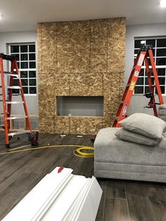 a living room filled with furniture next to a fire place in the middle of a building