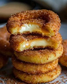 some donuts are stacked on top of each other and have cheese in the middle