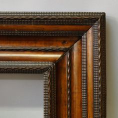 an old wooden frame hanging on the wall