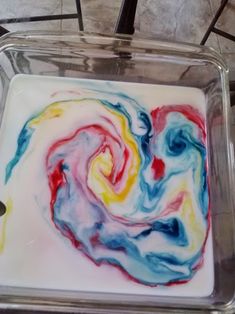 a square glass dish with multicolored swirls on it