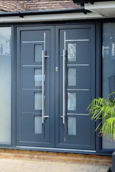 a blue front door with glass panels and sidelights