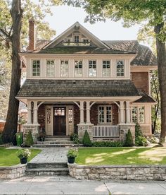 a large house with lots of windows in the front yard