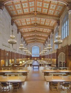 the inside of a large building with tables and chandeliers