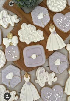 decorated wedding cookies are arranged on a table