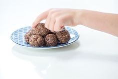 a person reaching for some food on a plate