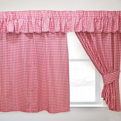 a red and white checkered curtain hanging on the side of a window sill