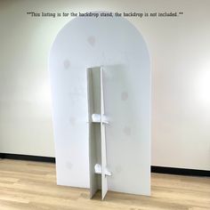 a large white display case sitting on top of a hard wood floor next to a wall