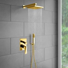 a shower head with thermostaer and hand held shower faucet in gold