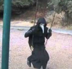 a person in a black hoodie swinging on a green pole with the caption, me relaxing after a long day of bloodbathing