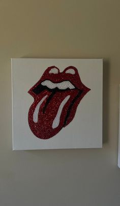 the rolling stones'tongue is painted on a white canvas with red and white beads