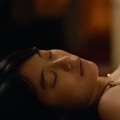 a woman laying down with her eyes closed