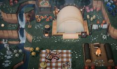 an aerial view of a picnic area with food and decorations on the ground, including a large inflatable tent