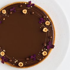 a plate with some food on it that is decorated like a chocolate cake and flowers