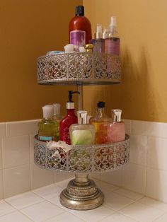 a three tiered tray with soaps and lotions on it