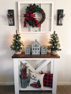 a christmas display with wreaths and decorations on the shelf next to other holiday decor