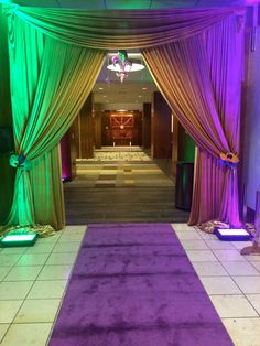 a purple and green stage set up for a party