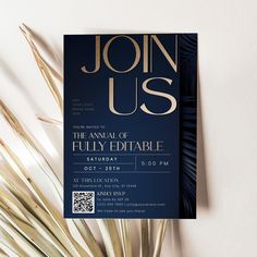 a blue and gold party card with palm fronds next to it on a white surface