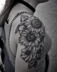 a woman's shoulder with sunflowers on it