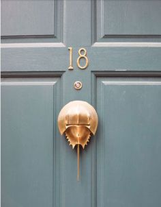 a blue door with a gold number on it