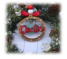 an ornament hanging on the side of a door with pine cones and berries