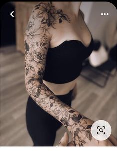 a woman with tattoos on her arms and arm