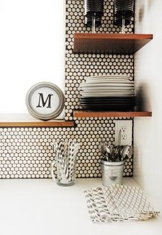 a kitchen shelf with plates and utensils on it