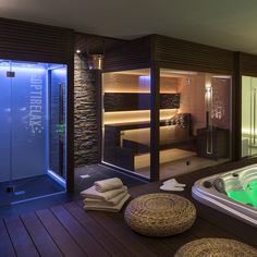 a spa room with a large jacuzzi tub next to a walk in shower