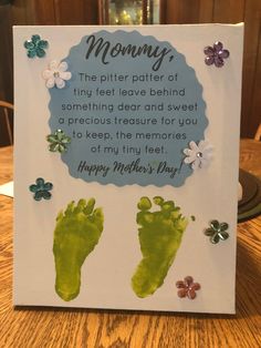 a hand and foot print on a card for a baby's first mother's day