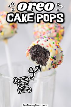 cake pops with white frosting and sprinkles in a clear glass cup