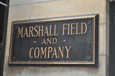 a sign on the side of a building that says marshall field and company