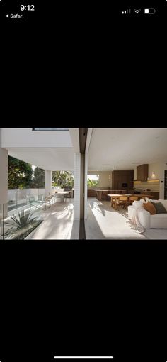 an open living room and dining area in a house with white walls, floor to ceiling windows