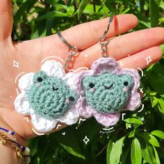 two crocheted keychains in the palm of someone's hand