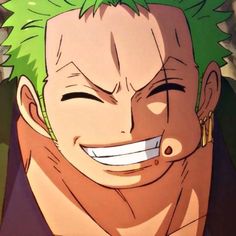 a man with green hair smiling at the camera