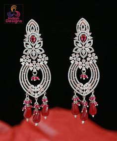 Another Beautiful Floral design long drop earrings from IndianDesigns. Bollywood inspired American diamond earrings in rose gold background. Elegant Pink Earrings For Reception, Elegant Pink Bridal Earrings For Reception, Rose Gold Danglers For Wedding, Diamond Long Earrings, Gold Rose Earrings, Rose Gold Background, American Diamond Earrings, Rose Gold Backgrounds, Indian Designs