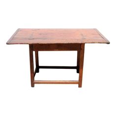 an old wooden table with two legs and one leg missing the top, against a white background