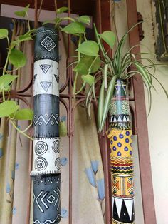 several decorative vases with plants in them