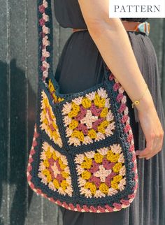 a woman is holding a crocheted purse